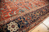 Antique Fereghan carpet section with detailed rust, navy, green, and gold floral patterns.