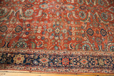 Antique Fereghan carpet detail: vibrant rust ground with intricate green, gold, and blue floral motifs.