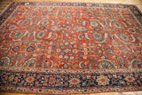 Antique Fereghan carpet corner: intricate navy border and earth tone rust floral field.