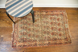 Antique Lavar Kerman rug corner with signed inscription cartouche and distressed paisley pattern.