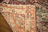 Hand-knotted weave and distressed fringe on the back of an antique Kerman rug.