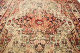 Worn texture and angular floral motifs on a geometric antique Kerman rug.