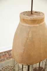 Skirt form's lower edge with deep fabric patina and detailed wire cage structure.