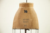 Patinaed canvas skirt form with original blue label and 'MODEL 1915 36' stencil.