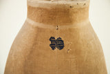 Vintage skirt dress form's original blue Kramer Bros label and deep fabric patina.