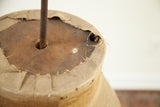 Rusted metal rod, weathered wood, and deeply patinated fabric of the vintage skirt dress form top.