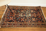 Worn blue field detail, geometric bird motifs, and V-shaped patterns on border.