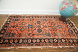 Worn pile and short cream fringe on vintage Lilihan rug corner with dark border.