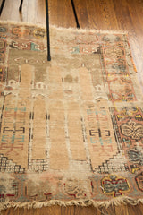 Tattered antique Turkish prayer rug revealing blanched light gold and beige hues.