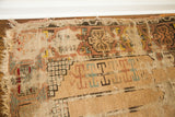 Worn, blanched geometric motifs and tattered fringe detail of antique Turkish prayer rug.
