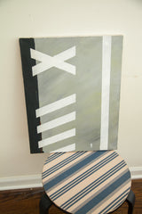 Angled view of the minimalistic modern painting showing its graphic black, white, and grey forms.