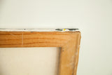 Reverse corner detail of the vintage painting's wooden stretcher frame and canvas.
