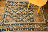 Antique Caucasian Shirvan rug with geometric dark blue, light brown, and reddish-orange patterns. 3'9