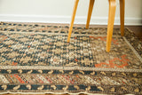 Antique Shirvan region rug showcasing geometric dark blue and orange-tan motifs.