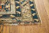 Storied fringe and deep blue geometric border of an antique Shirvan rug, circa 1900.