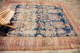 Unusual weeping willow motif on the distressed dark blue field of this antique Kerman rug.