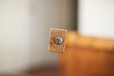 Close-up of Thonet bent plywood chair's aged wood with metal fastener and patina.