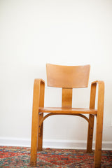 Vintage Thonet bent plywood chair showing aged patina and backrest chip.