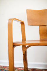 Vintage Thonet bent plywood chair leg, showing curved contours and aged patina.
