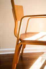 Bent plywood leg of the vintage Thonet chair, showing its natural patina.