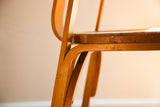Bent plywood contours and rich patina on the side of a vintage Thonet chair.