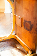 Curved bent plywood frame and rich wood patina on the vintage Thonet chair's underside.