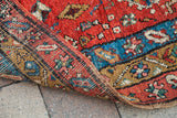 Robust hand-knotted construction revealed on the reverse of the vivid red antique Heriz fragment.