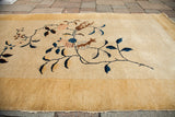 Art Deco floral vines on thick canary yellow pile of an antique Chinese rug.