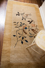 Thick cream pile on an Art Deco Chinese rug, showing blue and soft brown floral motifs.
