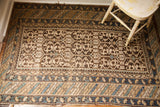 Early 20th century Caucasian rug's geometric pattern and striped tribal borders in earth tones.