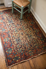 Vintage Persian Tabriz rug: allover scrolling design on light gold field, tattered red border.