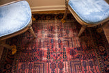 Vintage Persian Lilihan rug with raspberry red field and dark blue willow tree motifs.