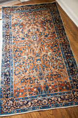 Antique Persian Yezd rug corner: gold tree-of-life, blue birds, contrasting borders, and fringe.