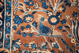 Detail of antique Persian Yezd rug: deep gold field, blue bird, vining florals.