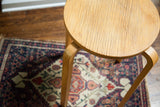 Vintage Alvar Aalto style high stool, circular wood top with striations and crackling.