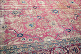 Distressed rose field with pale blue floral vines and intricate contrasting Kerman rug border.