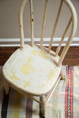 Antique child's Windsor chair seat with chippy ivory and yellow paint finish.