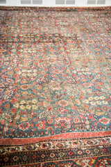Antique Fereghan carpet: green/teal field with allover pomegranate, madder root rust borders.