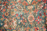 Vivid green field of antique Persian Fereghan rug, allover pomegranate motif, visible rewoven areas.