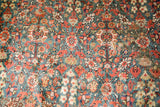 Antique Persian rug close-up: green teal field, allover floral motifs, storied restorations.