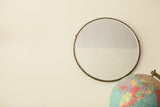 Large round antique beveled glass mirror, early 20th century, dark scalloped edge.