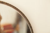 Antique mirror's scalloped and beveled glass edge detail.