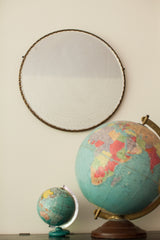 Aged beveled glass and scalloped edge on a large antique mirror.