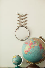 Vintage beveled glass shaving mirror featuring an extended metal accordion arm.