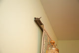 Original wooden roller and metal bar mechanism of the antique pull-down map.