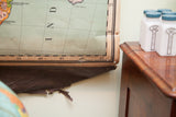 Vintage classroom pulldown map of Africa with visible holes and tears on lower edge.