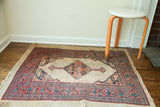 Late 19th century distressed Persian Serab rug, tattered camel hair field, geometric coral and blue patterns.