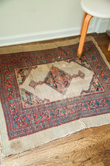 Frayed edge and rich patina on the artfully worn pile of a Persian Serab rug.