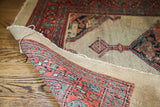 Worn geometric pile and woven foundation of a distressed antique Persian Serab rug.