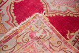 Hand-knotted weave and raspberry red pile with intricate saffron border patterns.